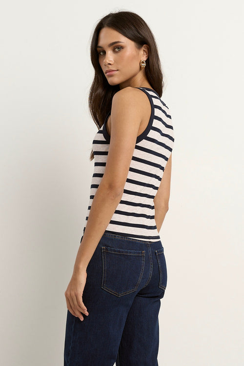 model wears a navy white stripe tank with blue jeans
