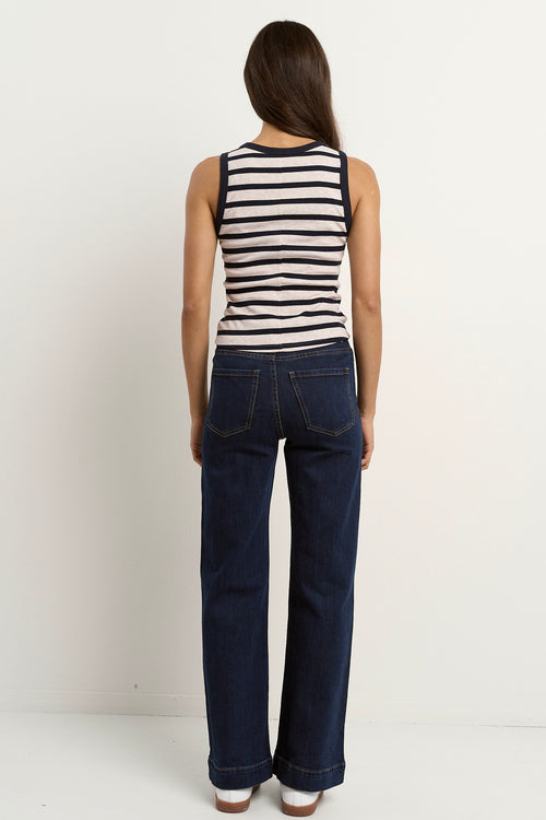 model wears a navy white stripe tank with blue jeans