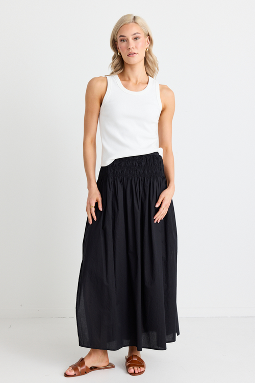 model wear white tank top and black skirt