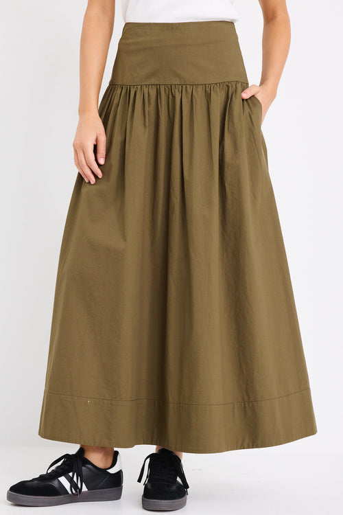 model wears a khaki maxi skirt with a white tank top