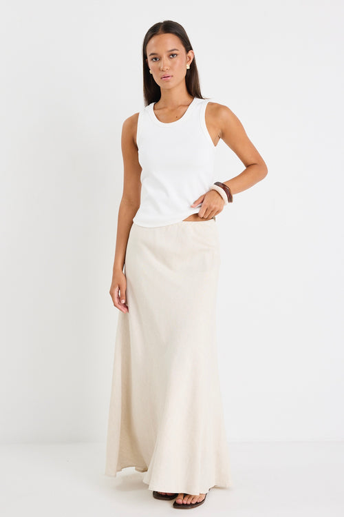 model wears white tank top and a natural linen skirt