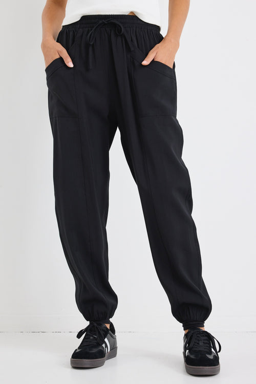 model wears a black drawstring jogger
