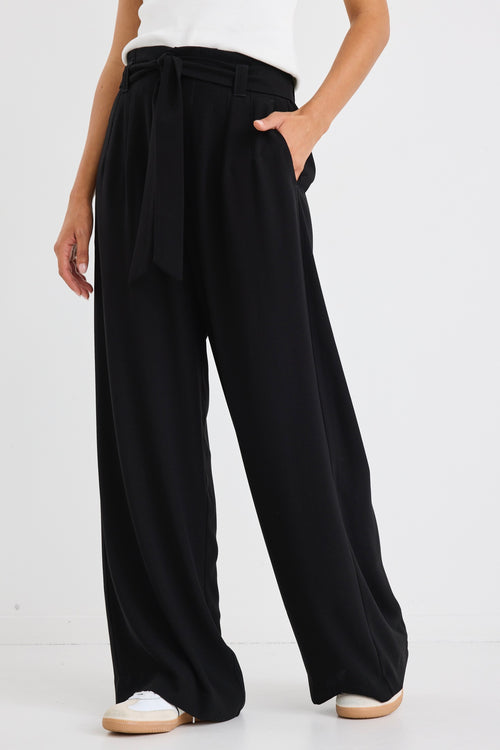 model wears a wide leg black pant