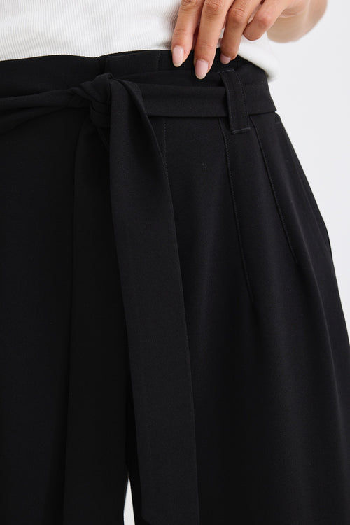 model wears a wide leg black pant