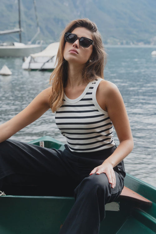 model wears a white black stripe tank top