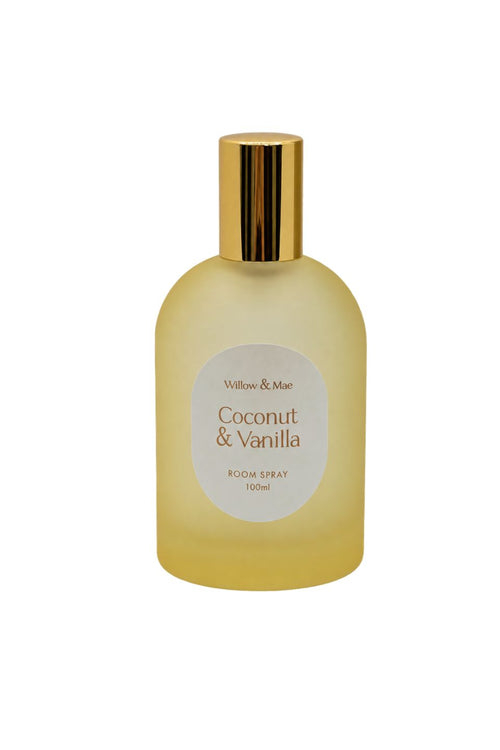 A 100ml bottle of Willow & Mae Coconut & Vanilla Room Spray, featuring a translucent pale yellow-green bottle with a shiny gold cap and a white circular label.