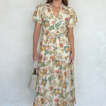 Woman wearing a floral dress against a white background