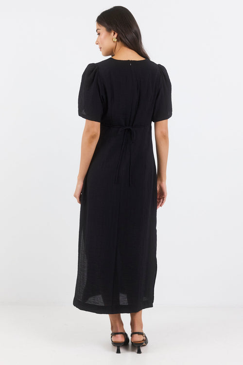 Woman wearing a black dress on a white background