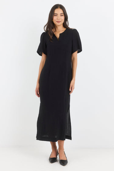 Woman wearing a black dress on a white background