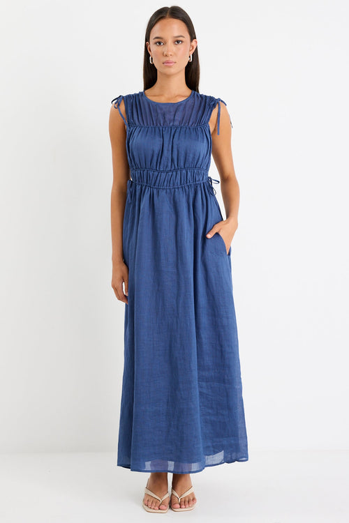 Woman wearing a navy ruched maxi dress