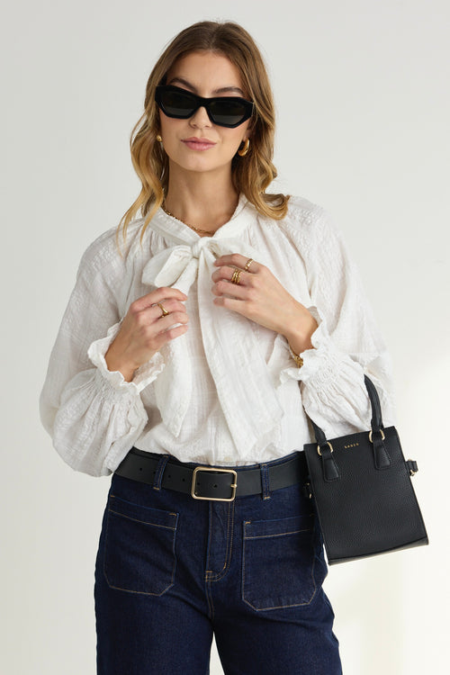 model wears a White Long Sleeve Blouse