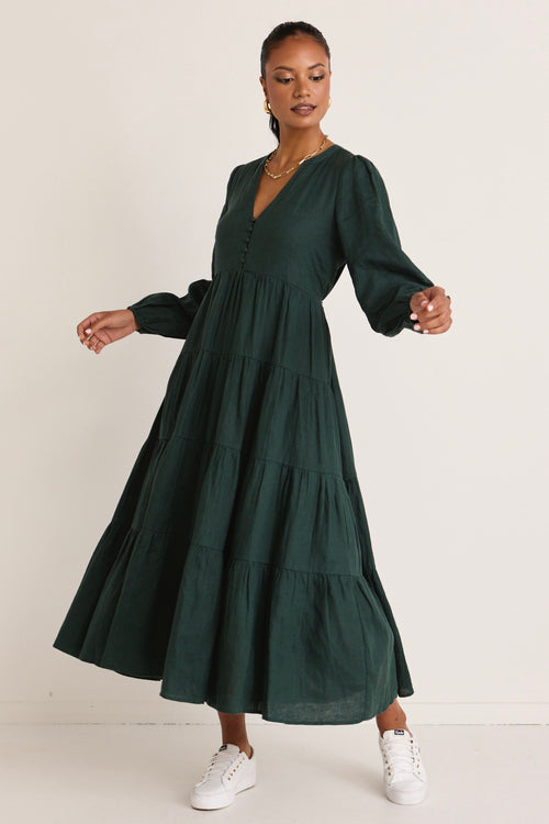 model wears a green maxi dress