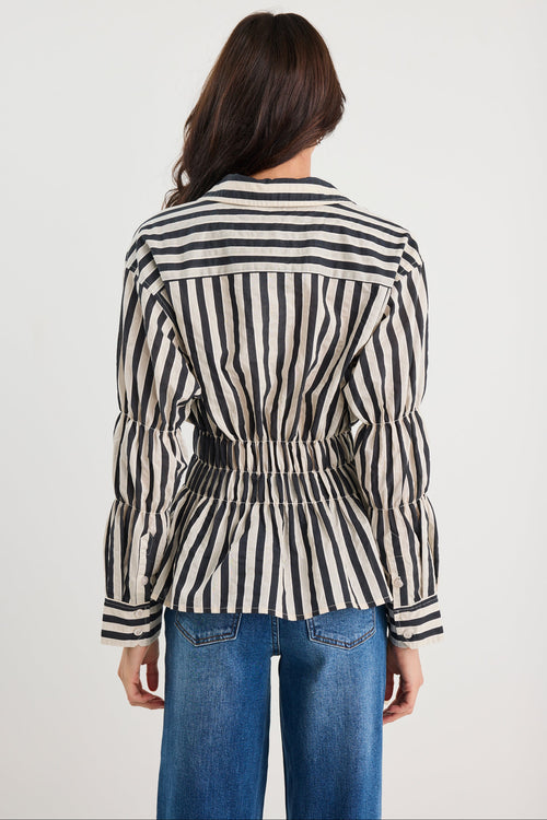 Person wearing a black and white striped shirt with a white background