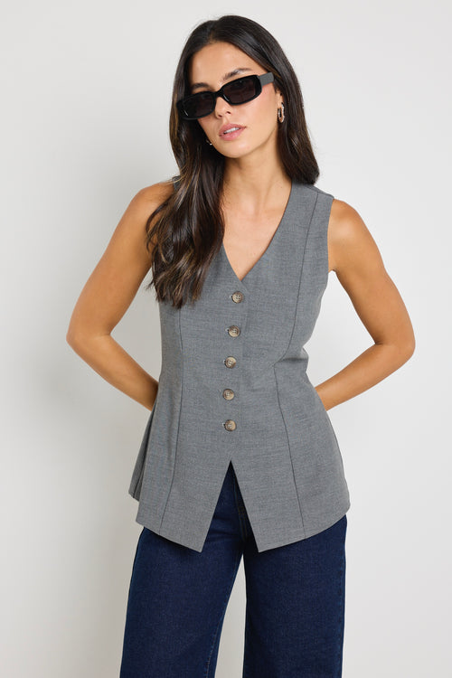 model wears grey button up v neck vest