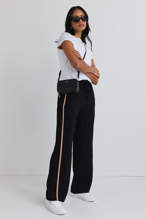 model wears black natural stripe pant