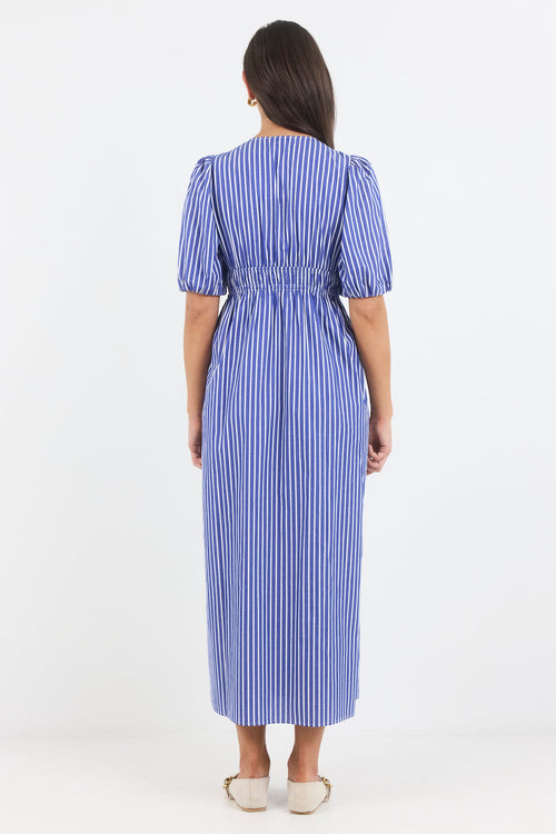 Woman wearing a blue and white striped dress on a white background
