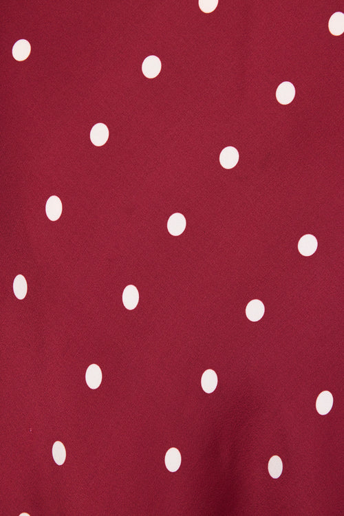 Maroon fabric with white polka dots