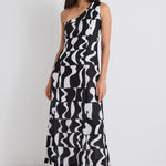 model wears a one shoulder black and white print dress