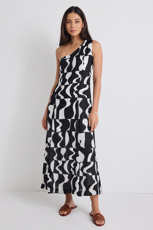 model wears a one shoulder black and white print dress