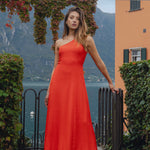 model wears a one shoulder red maxi dress