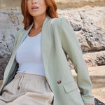 model wears a green blazer