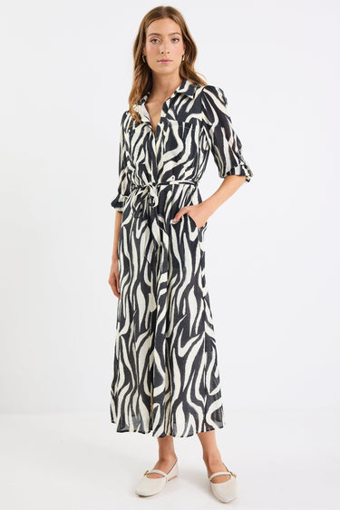 Woman wearing a zebra print dress on a white background