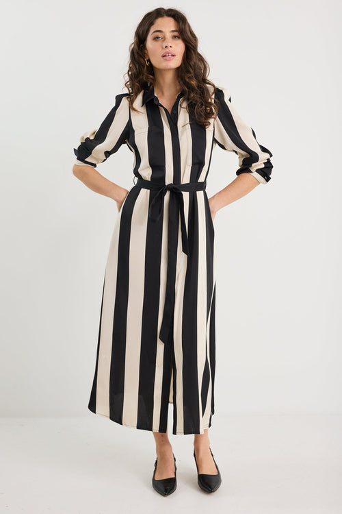 Woman wearing a black and white striped dress on a white background