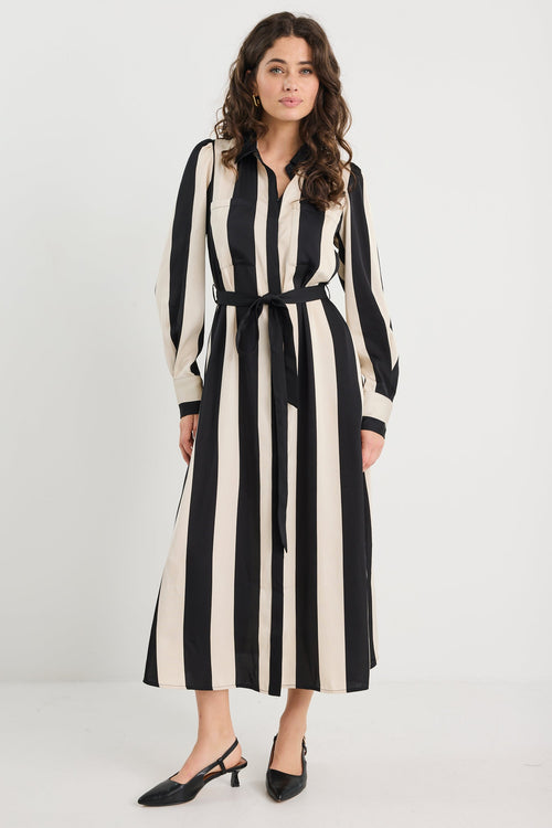Woman wearing a black and white striped dress on a white background