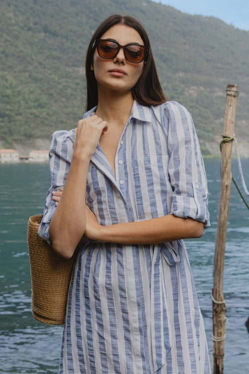 model wears blue and white stripe midi dress