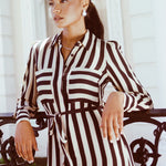 model wears a black stripe shirt dress