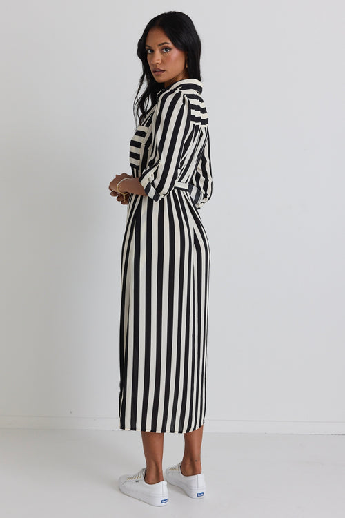 model wears a black and white stripe midi dress