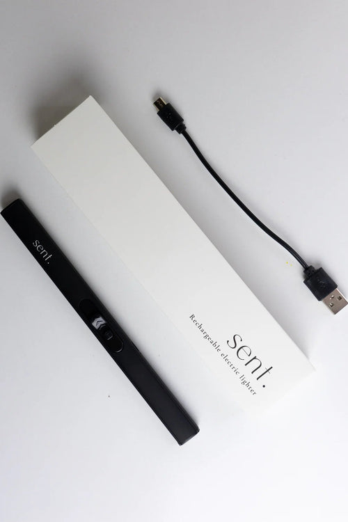 A black Sent disposable vape device shown next to its white packaging box and a black USB charging cable on a clean white background.