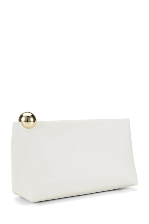 A minimalist white leather clutch bag with a gold metallic ball accent on the front, set against a solid white background.