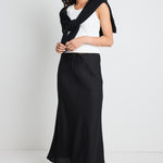 model wears a black linen maxi skirt