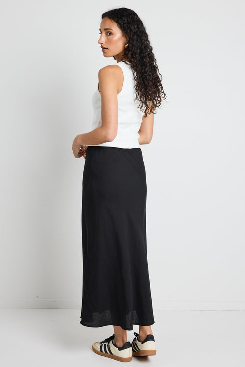 model wears a black linen maxi skirt