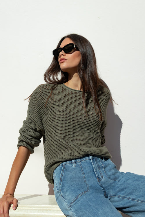 khaki knit jumper and blue jeans