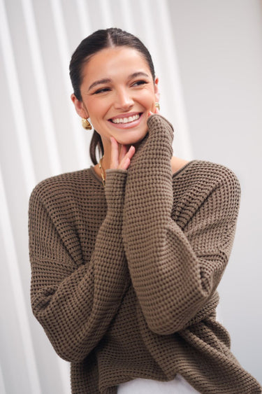 model wears green crochet knit jumper