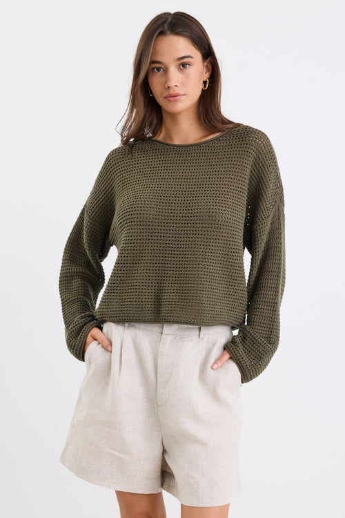 Model wearing a khaki knit and beige linen short
