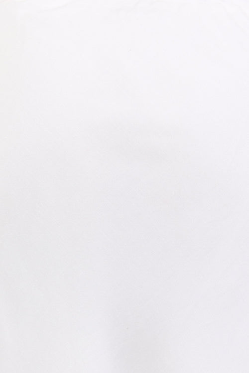 Close-up of a white skirt with a blurred background