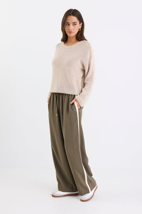 model wearing khaki pant with side stripe and drawstring waist