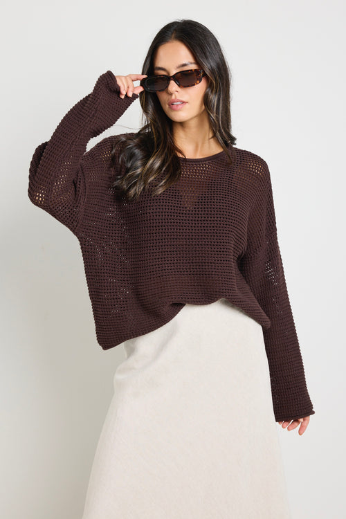 model wears a brown crochet knit jumper