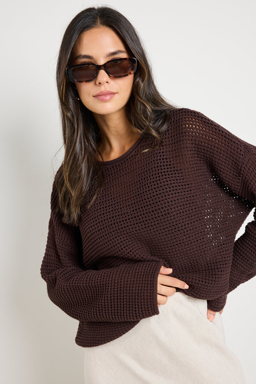 model wears a brown crochet knit jumper