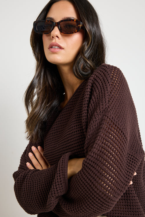 model wears a brown crochet knit jumper