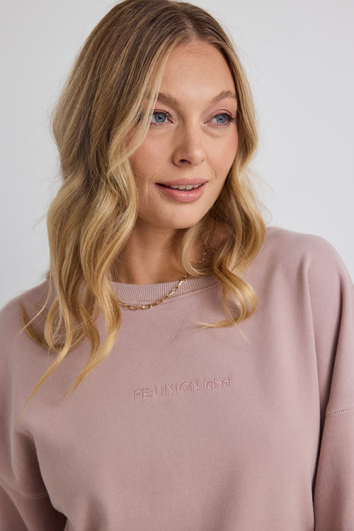 model wears pink jumper