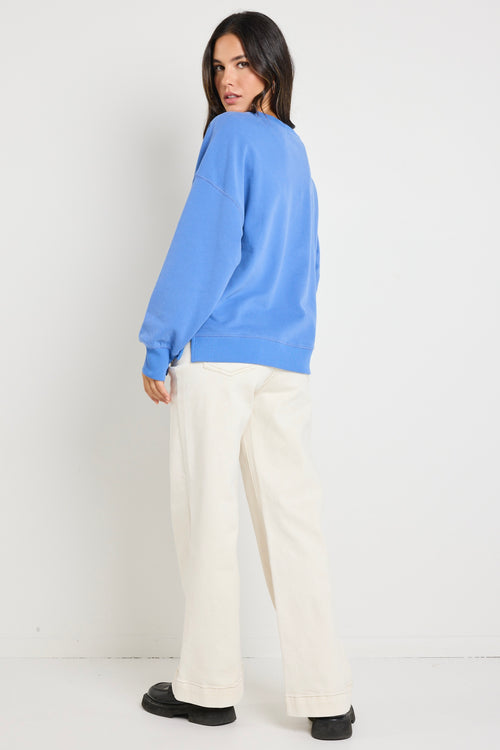 Model wears a blue jumper