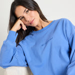 Model wears a blue jumper