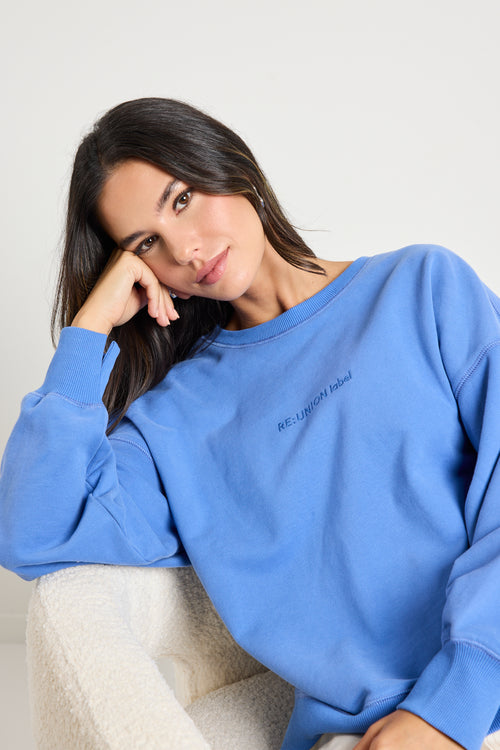 Model wears a blue jumper