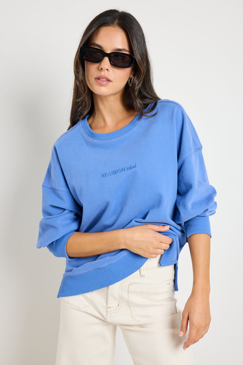 Model wears a blue jumper