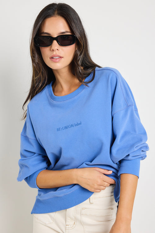 Model wears a blue jumper