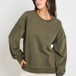 Model wears a khaki green long sleeve sweatshirt 